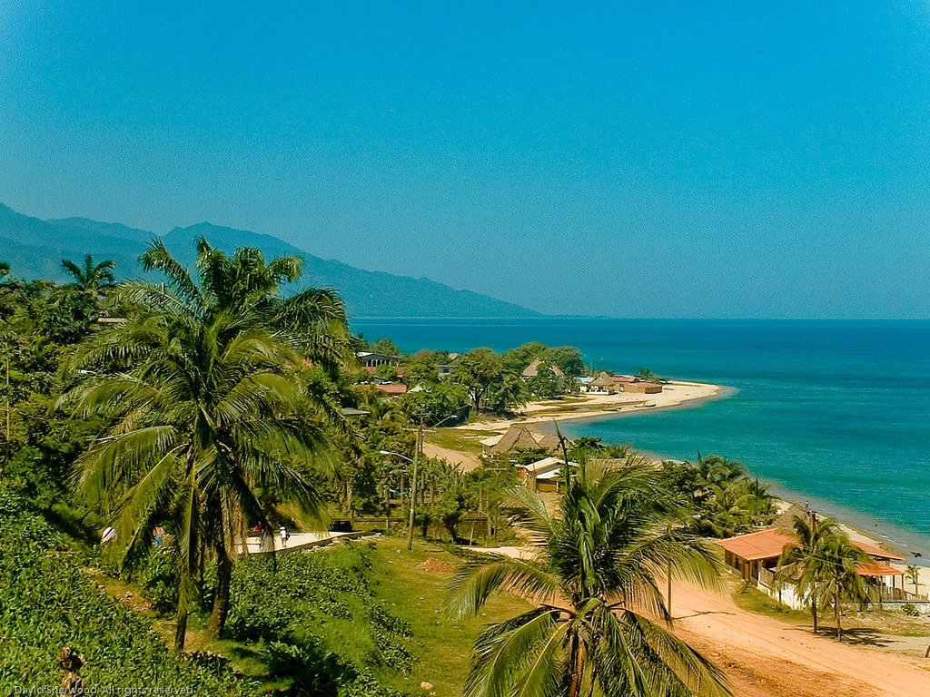 "Trujillo's pristine beach with clear waters and sandy shorelines under a blue sky"